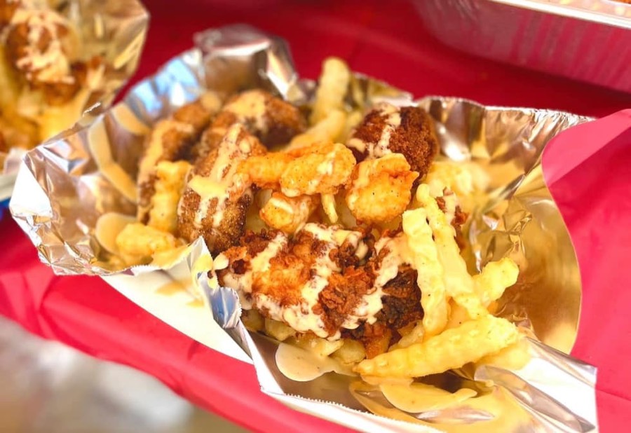 Sampler — catfish filet, shrimp, and chicken with a hushpuppy on fries