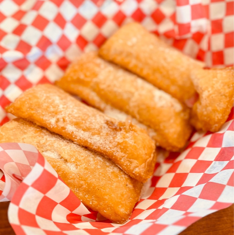 Hand-fried apple hand pies dusted with sugar