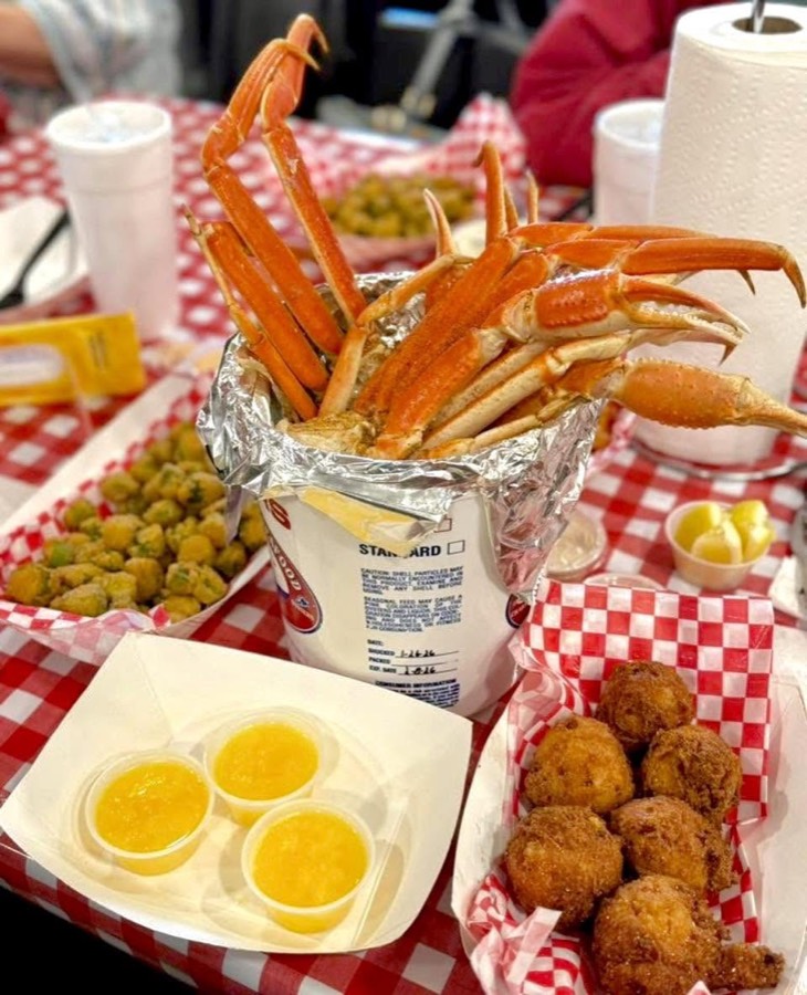 Snow crab legs with butter dipping sauce and hushpuppies