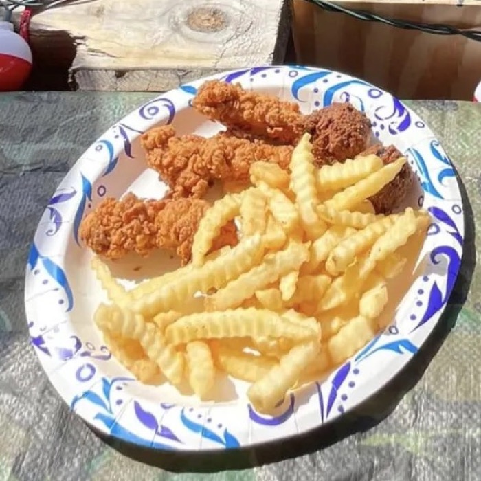 Kids chicken tenders and fries on a paper plate