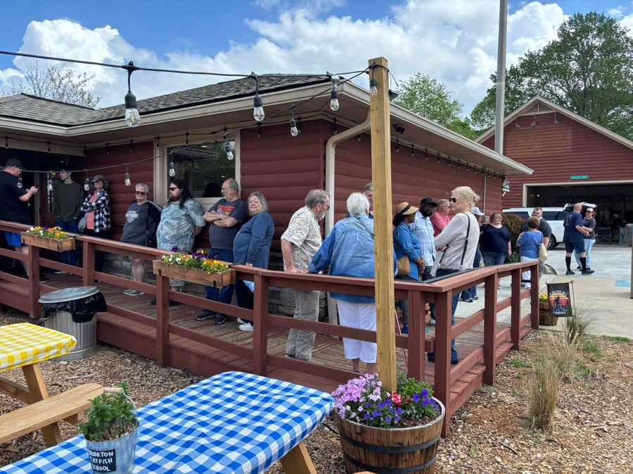 Customers lined up on the patio waiting for a table